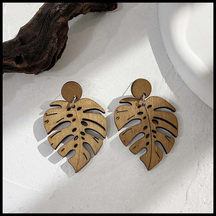 A pair of eco friendly handmade wood earrings in the shape of leaves - hypoallergenic